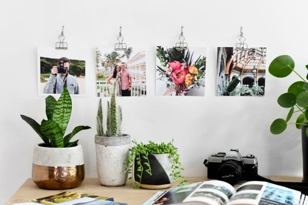Four Square Prints are hung over a desk using silver skeleton clips.