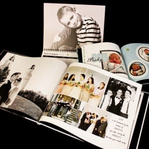 Several Family History Books made on MyCanvas are open to show family wedding photos and baby pictures.