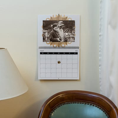 A MyCanvas Custom Wall Calendar hangs in a living room, showing that family photos make great home decor. A MyCanvas Custom Wall Calendar hangs in a living room, showing that family photos make great home decor.