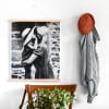 A black and white 16x20 Fine Art Print of a mother and son hangs from Maple Rails in an entryway.