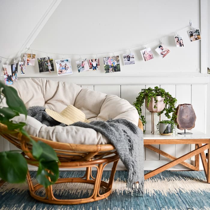 A string of Clip Lights holding Parabo Press Square Prints decorates a reading nook.