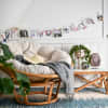 A string of Clip Lights holding Parabo Press Square Prints decorates a reading nook.