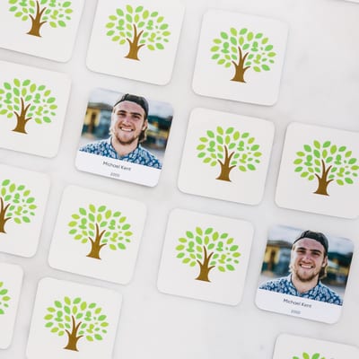 MyCanvas Family Flip memory game cards laid out on a marble surface, with tree-illustrated card backs and a photo card of Michael Kent.