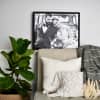 A Canvas Print of a wedding photo in a Black Frame is placed on a ledge behind a couch.