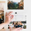 Hands place an 8x10 fine art print and Good Hangup magnet onto a magnetic sticker.