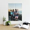A Newsprint of a happy family of four hangs from magnetic Good Hangups above a reading desk.