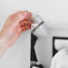 A hand places a Large Skeleton Clip on the corner of a photo print.