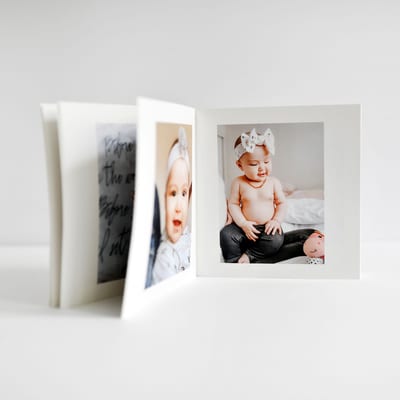 An open Softcover Photo Book with baby photos An open Softcover Photo Book with baby photos