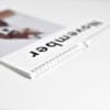 A closeup of the spiral binding of a custom photo Wall Calendar.