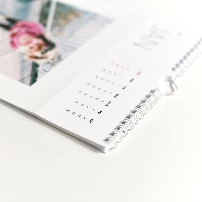 A closeup of the spiral binding of a Keepsake Wall Calendar.