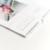 A closeup of the spiral binding of a Keepsake Wall Calendar.