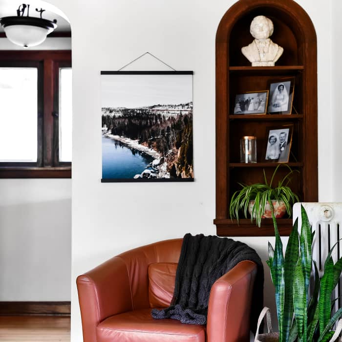 A matte Fine Art Print of a snowy vacation scene hangs from 20 inch Black Poster Rails.